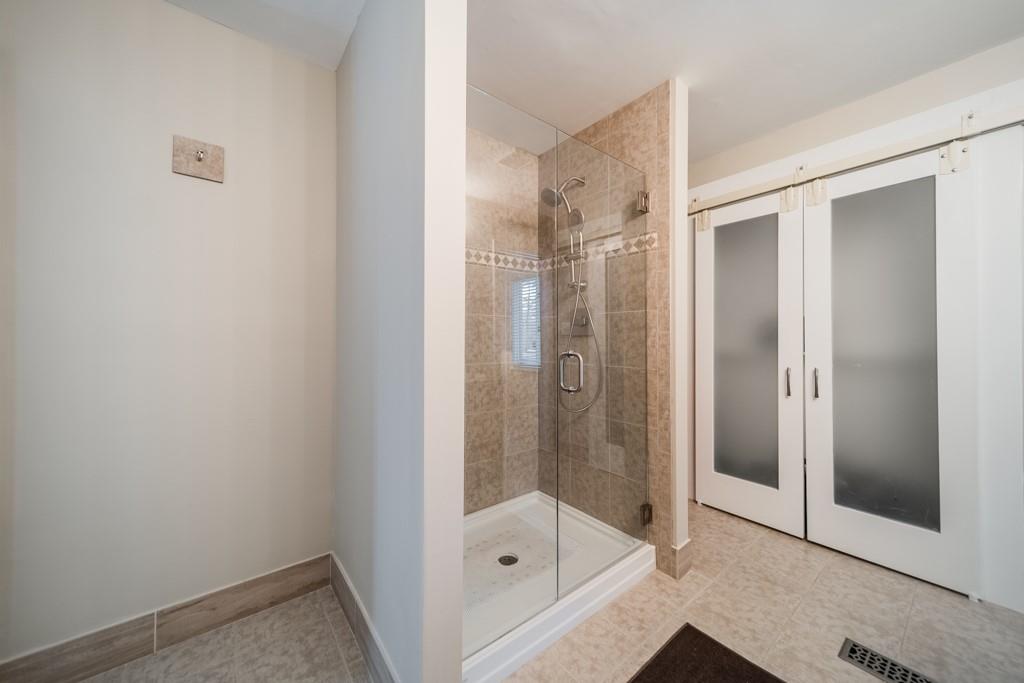 5111 Rounding Run Road Charlotte, NC 28277 - Photo 20 of 35 a bathroom with a glass shower door
