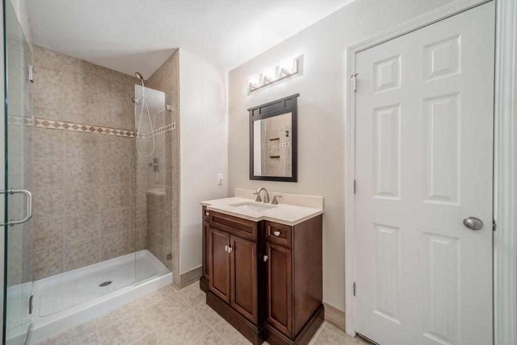 5111 Rounding Run Road Charlotte, NC 28277 - Photo 23 of 35 a bathroom with a sink a toilet and shower
