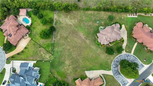 an aerial view of a house with garden space and lake view
