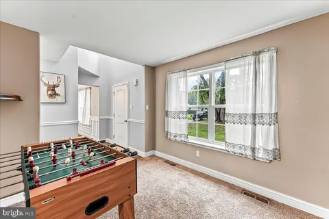 a living room with a bed furniture and a large window