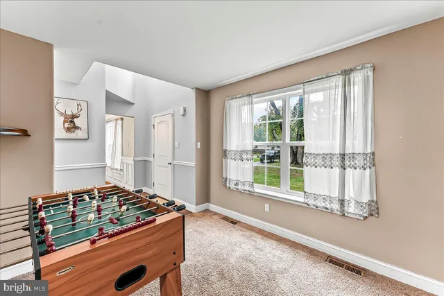 a living room with a bed furniture and a large window