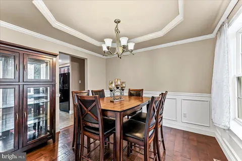 a view of a dining room with furniture wooden floor and chandelier