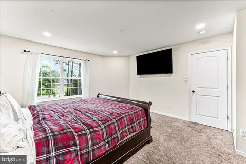 a bedroom with a large bed and a flat screen tv