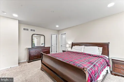 a bedroom with a bed and a dresser