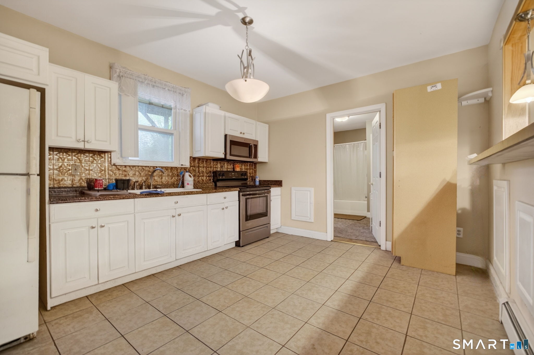 670 Hanover Road Meriden, CT 06451 - Photo 15 of 40 a kitchen with cabinets and window