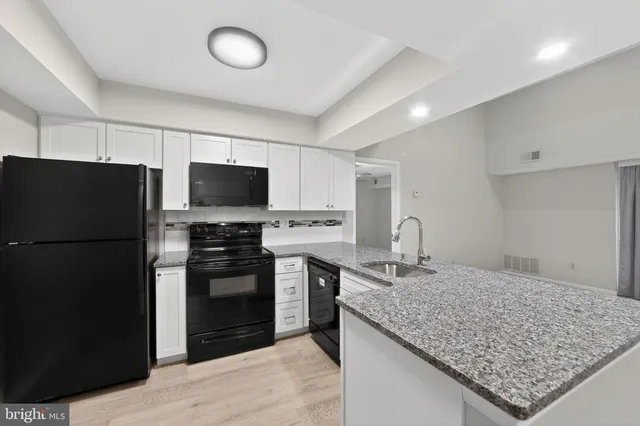 a kitchen with a refrigerator and a sink