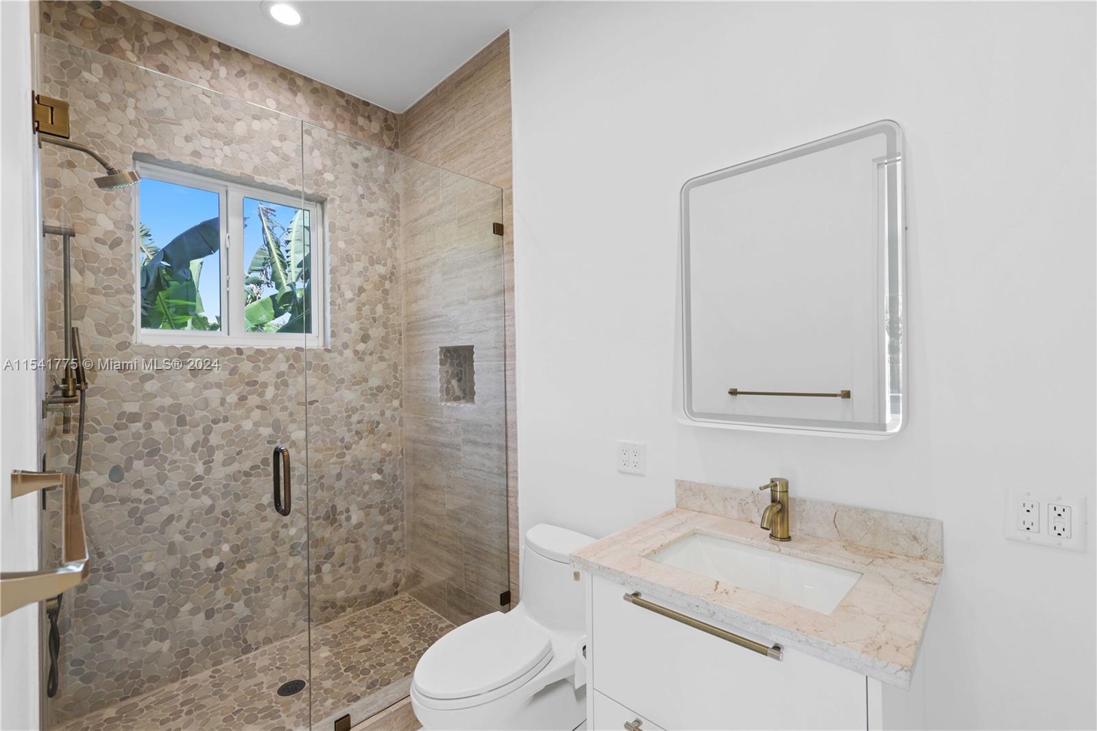 7153 Valencia Drive Boca Raton, FL 33433 - Photo 15 of 80 a bathroom with a granite countertop sink toilet a mirror and shower