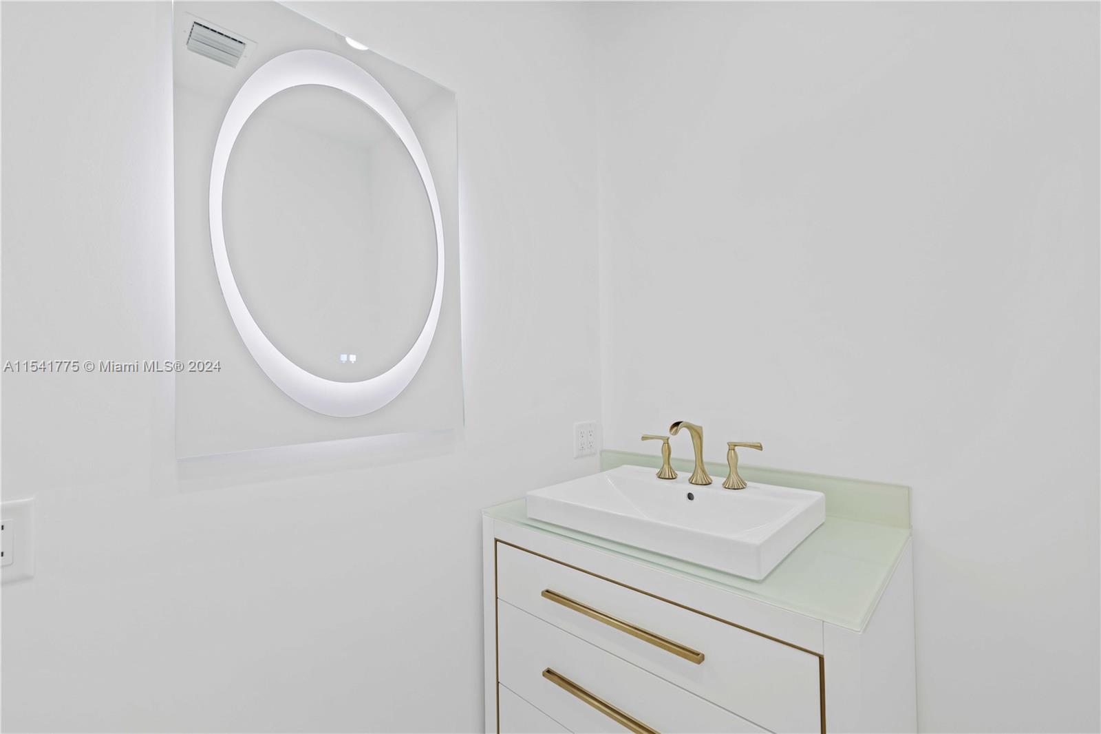 7153 Valencia Drive Boca Raton, FL 33433 - Photo 45 of 80 a bathroom with a sink and a mirror