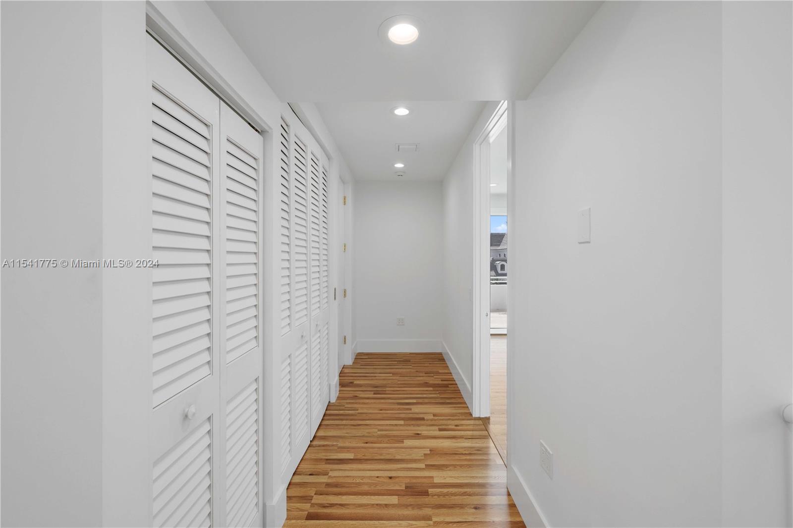 7153 Valencia Drive Boca Raton, FL 33433 - Photo 50 of 80 a view of a hallway with wooden floor and staircase