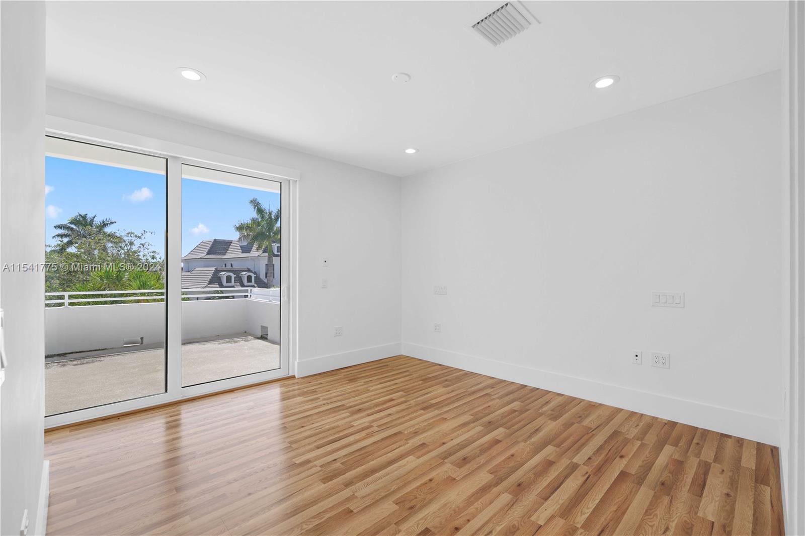 7153 Valencia Drive Boca Raton, FL 33433 - Photo 52 of 80 a view of a room with wooden floor and sliding door