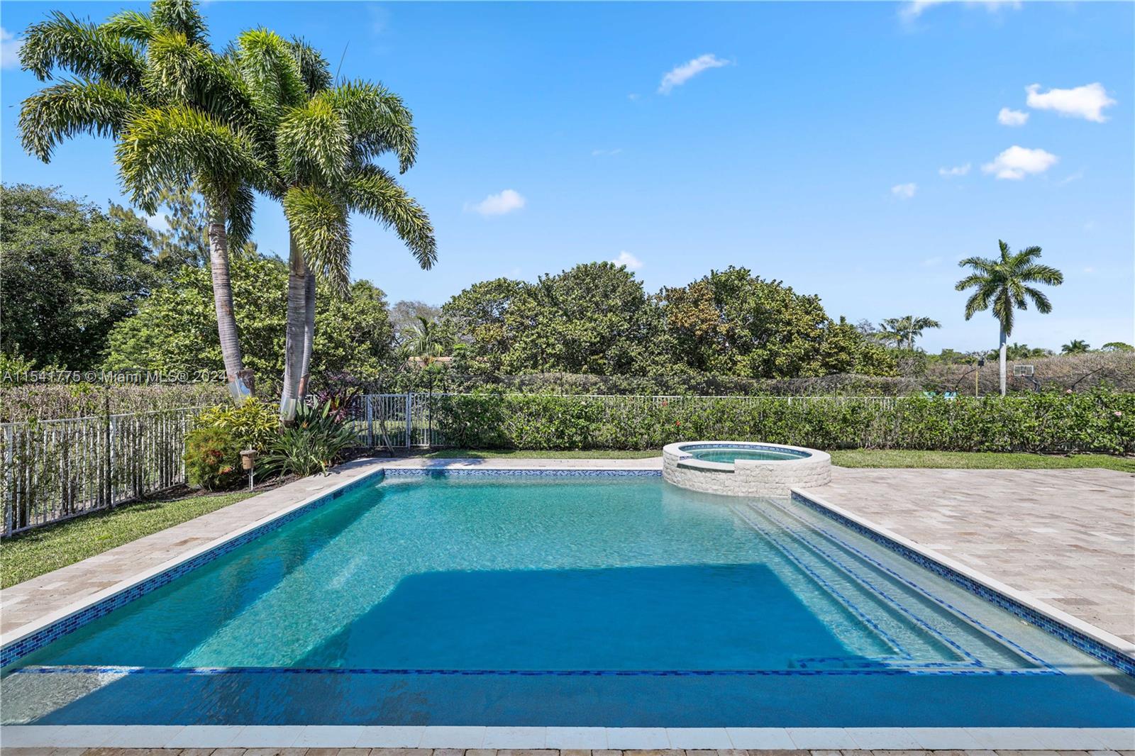 7153 Valencia Drive Boca Raton, FL 33433 - Photo 57 of 80 a view of a swimming pool and a yard