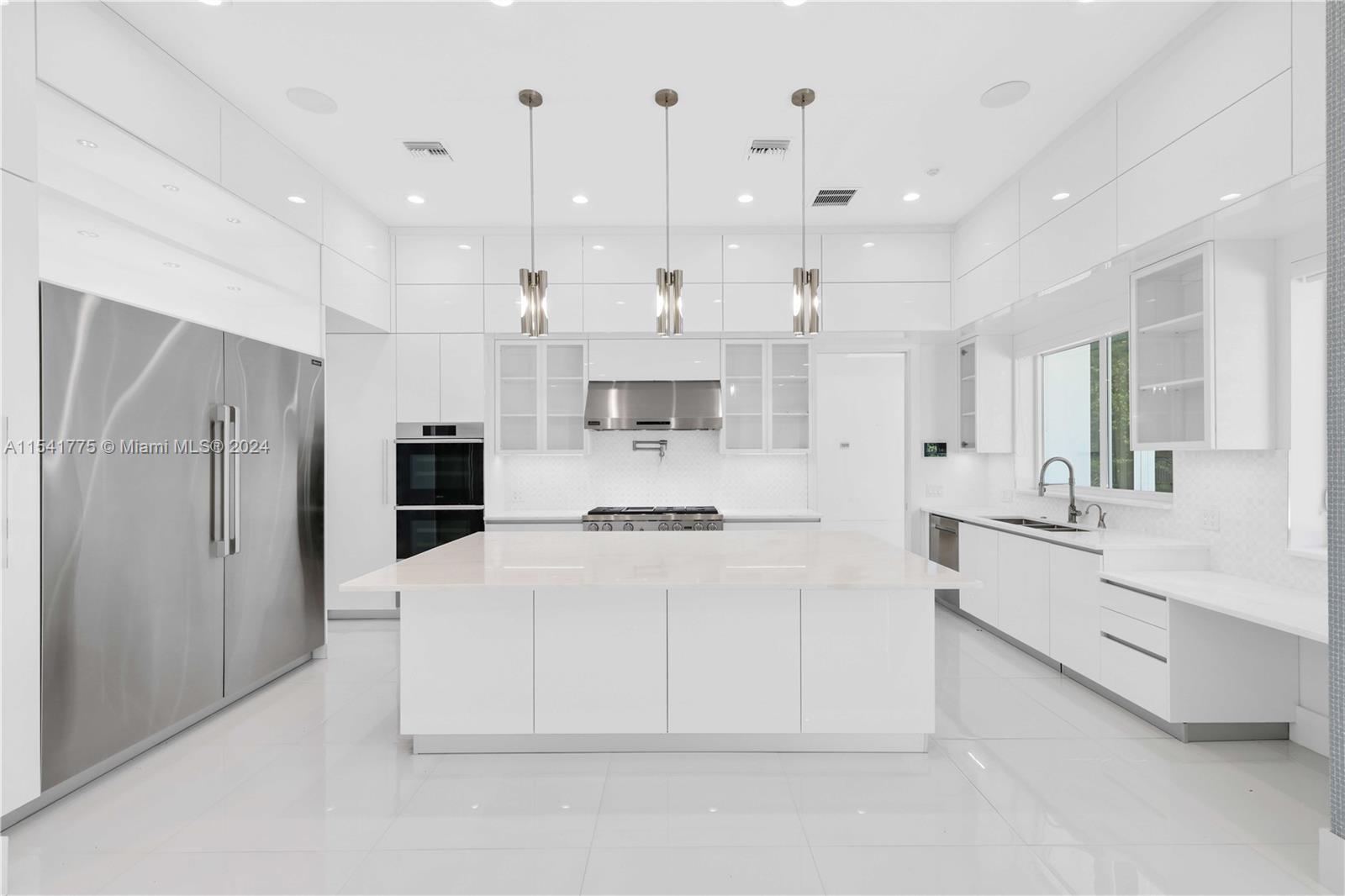 7153 Valencia Drive Boca Raton, FL 33433 - Photo 7 of 80 a large white kitchen with a white countertops a stove and a refrigerator