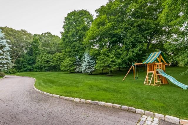 299 Ridgefield Road Wilton, CT 06897 - Photo 25 of 29 a view of a house with a yard