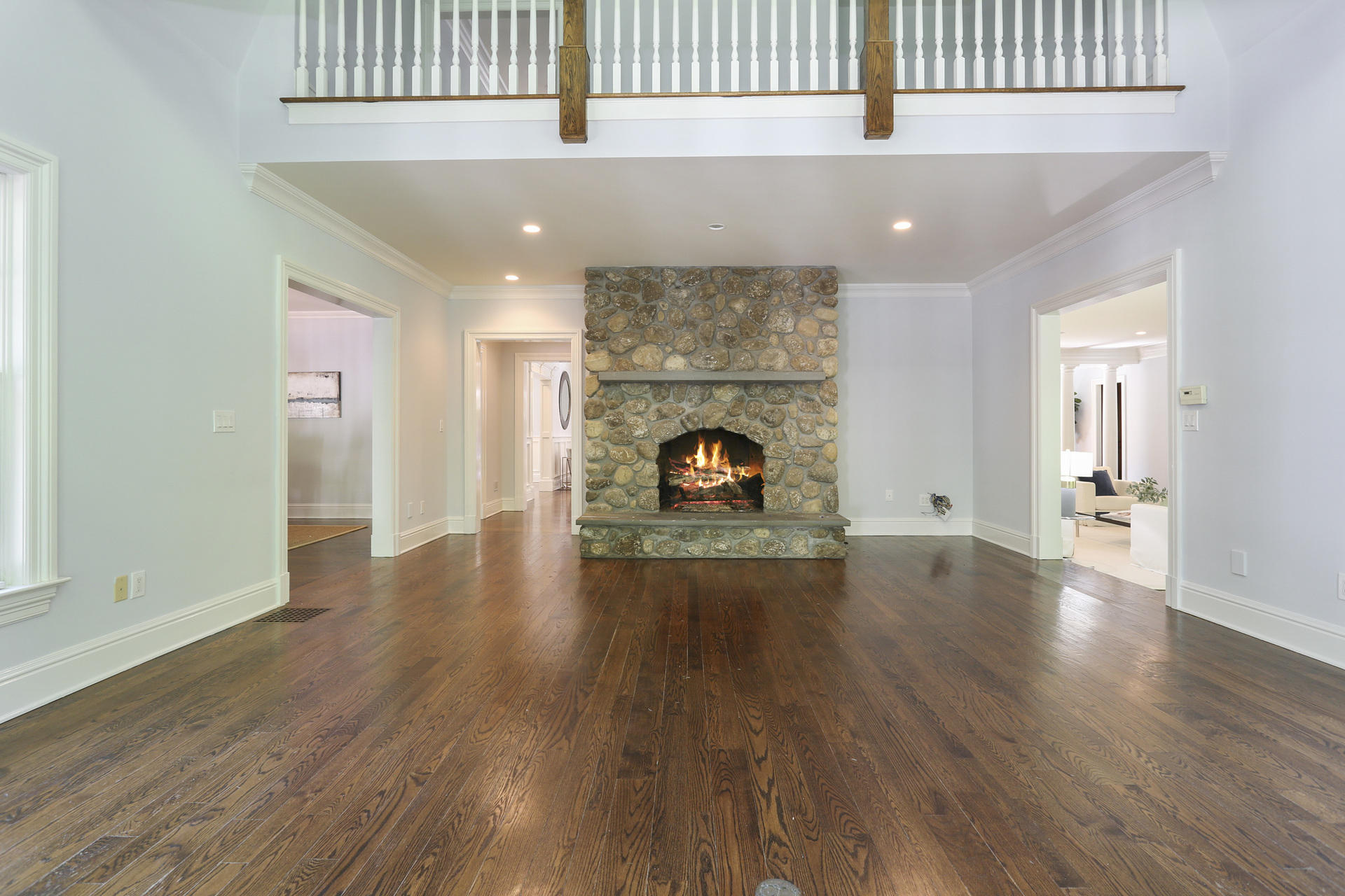299 Ridgefield Road Wilton, CT 06897 - Photo 6 of 29 an empty room with wooden floor fireplace and windows