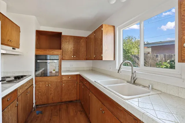 a kitchen with a sink stove and cabinets