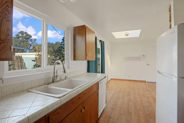 a kitchen with a sink and large window