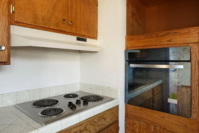 a kitchen with a stove and a microwave
