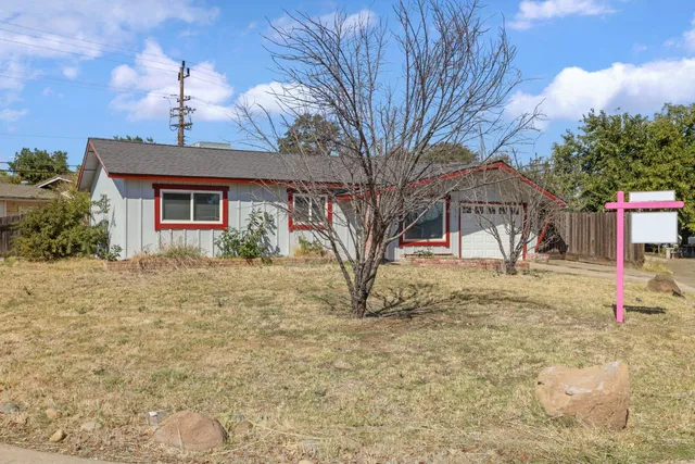 a house that has a tree in front of it