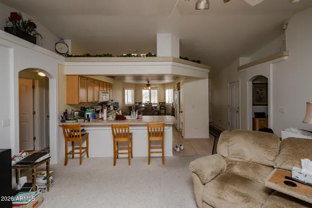 a room with furniture a large window and a sink