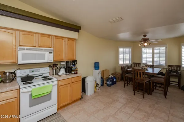 a living room with furniture and a kitchen area