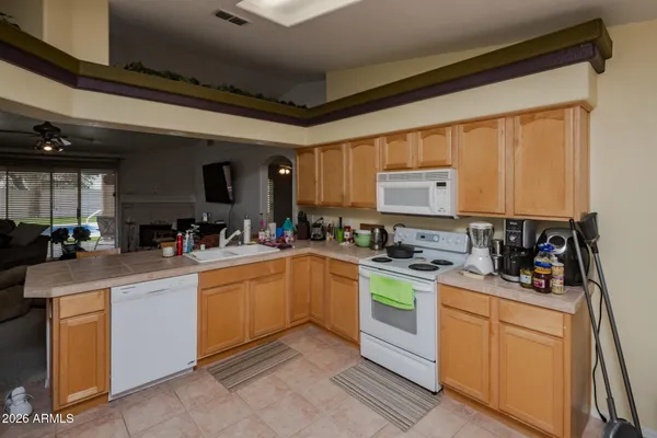 a kitchen with refrigerator and cabinets