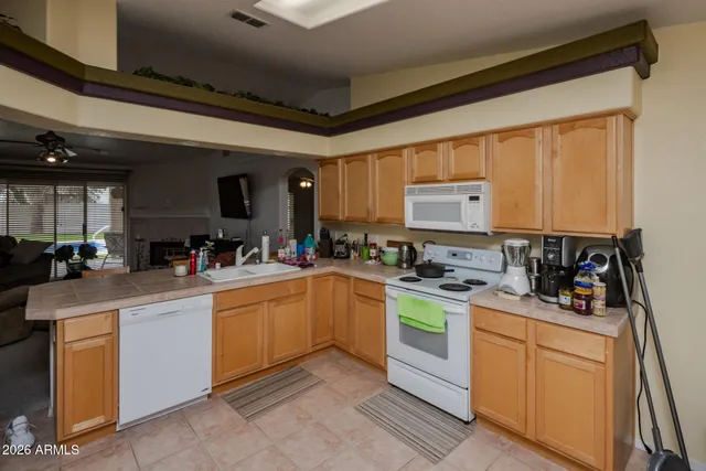 a kitchen with refrigerator and cabinets