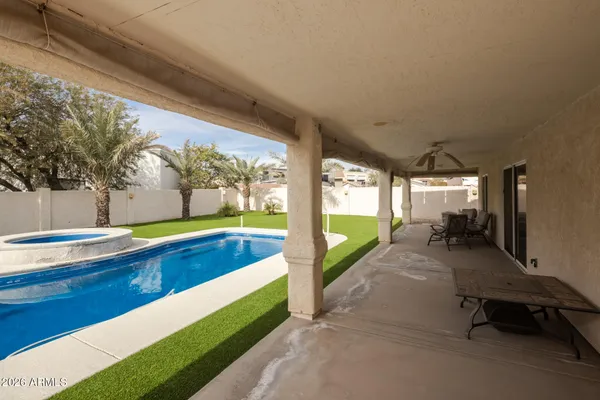 a swimming pool with outdoor seating and yard