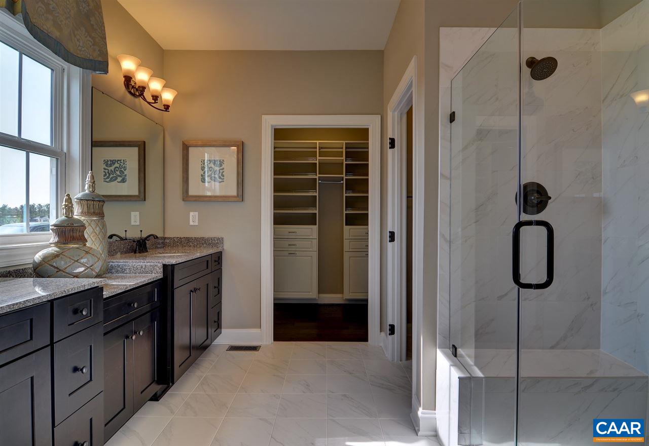 216 Ridgemont Road Ruckersville, VA 22968 - Photo 11 of 12 a bathroom with a granite countertop sink a vanity and a mirror