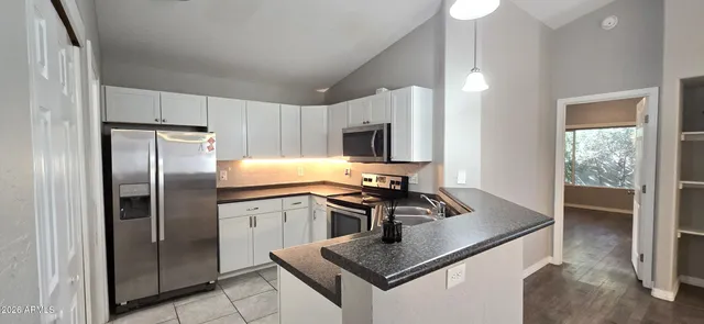 a kitchen with a refrigerator stove and microwave