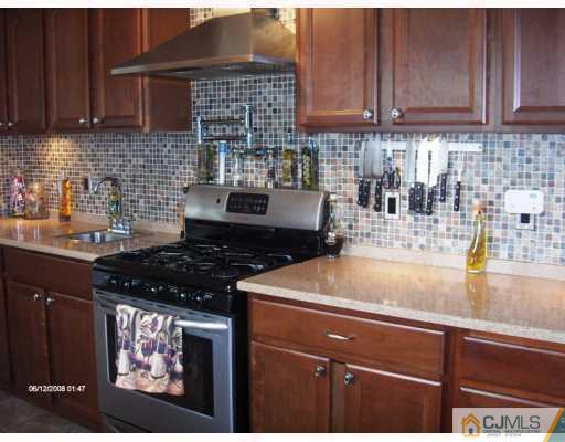 35 Windsor Road Edison, NJ 08817 - Photo 6 of 10 a kitchen with stainless steel appliances granite countertop a sink stove and cabinets