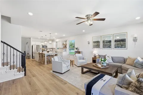 a living room with furniture and kitchen view