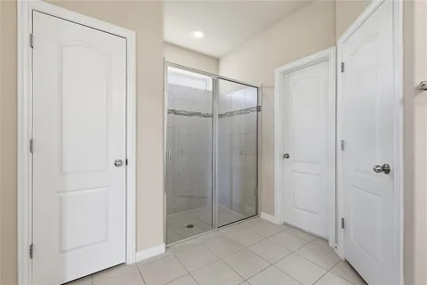 a bathroom with a shower and a glass door