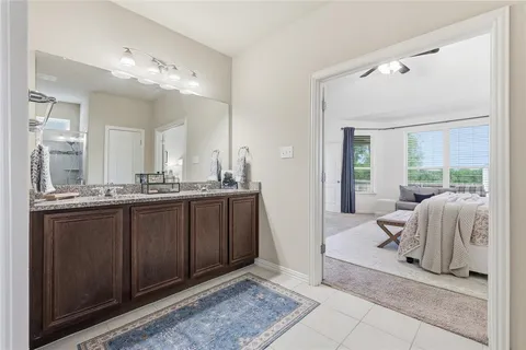 a spacious bathroom with a double vanity sink and a mirror