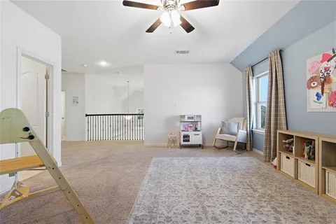 a bed room with a bed and a chair