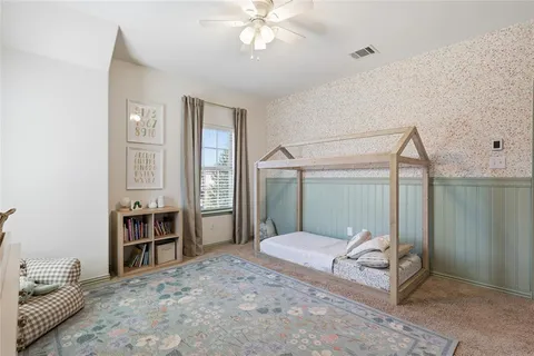 a bedroom with a bed and a chandelier