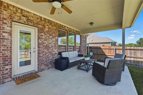 a living room with fireplace furniture and a large window