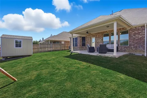 a view of a house with a yard and porch