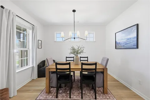 a view of a dining room with furniture window and wooden floor