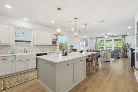 a kitchen with counter space sink stove and wooden floor