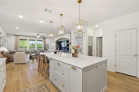 an open kitchen with sink and refrigerator