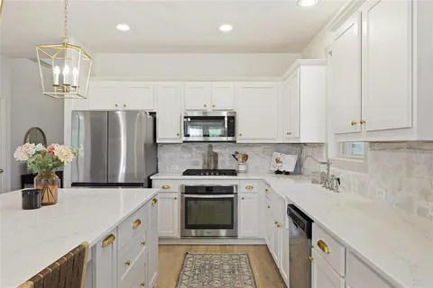 a kitchen with a sink a stove and refrigerator