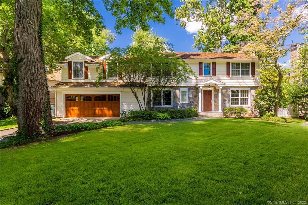 55 Winthrop Drive Greenwich, CT 06878 - Photo 1 of 1 a front view of a house with a yard