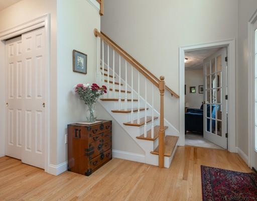337 Springs Road Bedford, MA 01730 - Photo 4 of 30 a view of entryway dining room and hall with wooden floor
