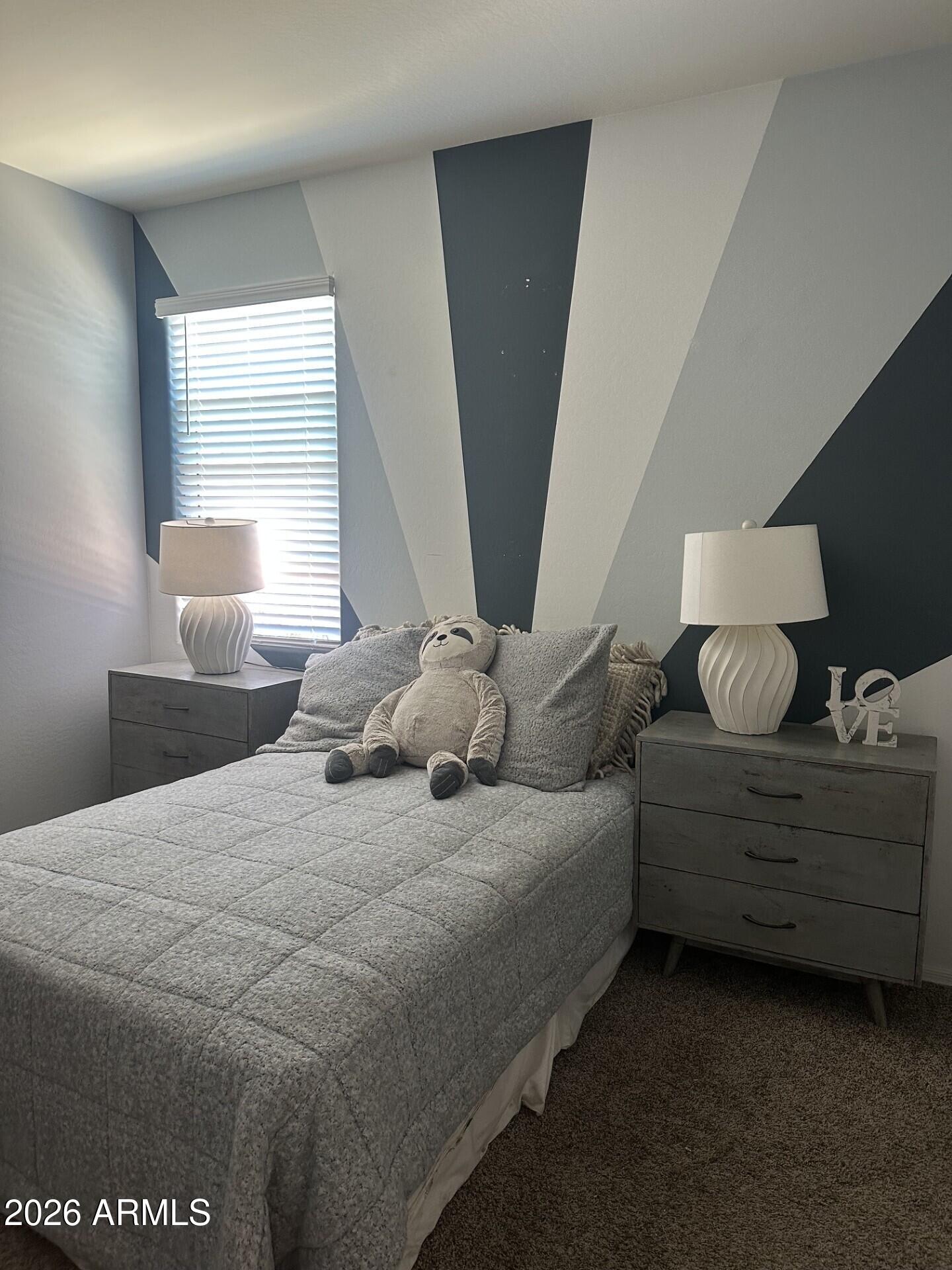 7851 West Riverside Avenue Phoenix, AZ 85043 - Photo 38 of 40 a bedroom with a bed and window