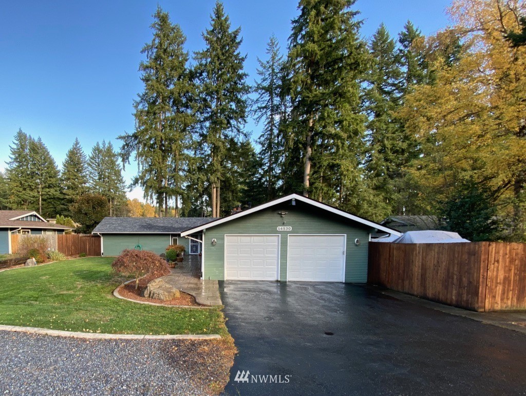a front view of house with backyard and green space
