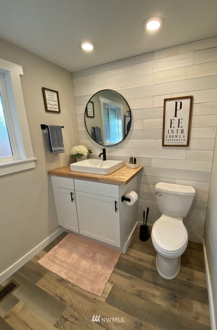 14530 166th Place Southeast Renton, WA 98059 - Photo 17 of 30 a bathroom with a toilet sink and mirror