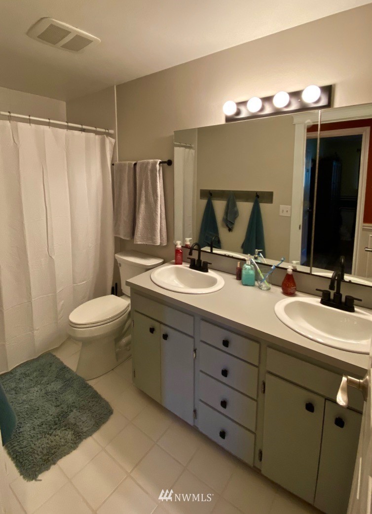 14530 166th Place Southeast Renton, WA 98059 - Photo 20 of 30 a bathroom with a double vanity sink and mirror