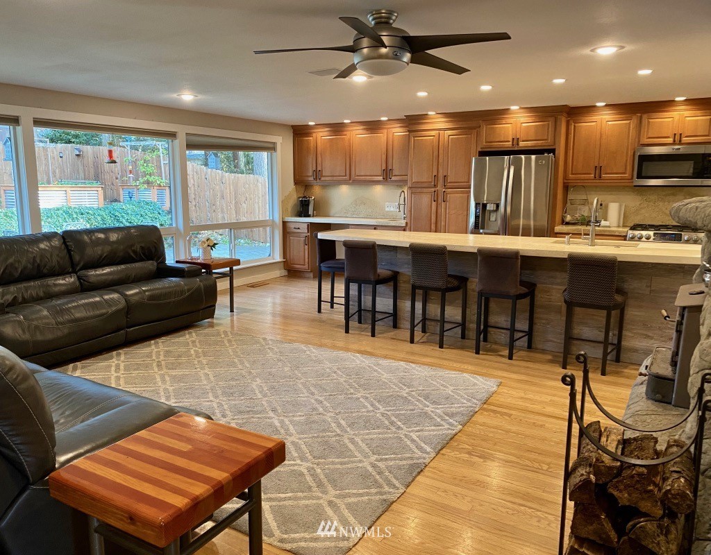 14530 166th Place Southeast Renton, WA 98059 - Photo 3 of 30 a living room with stainless steel appliances lots of furniture and a open kitchen