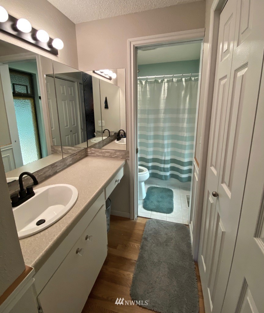14530 166th Place Southeast Renton, WA 98059 - Photo 26 of 30 a bathroom with a double vanity sink mirror and shower