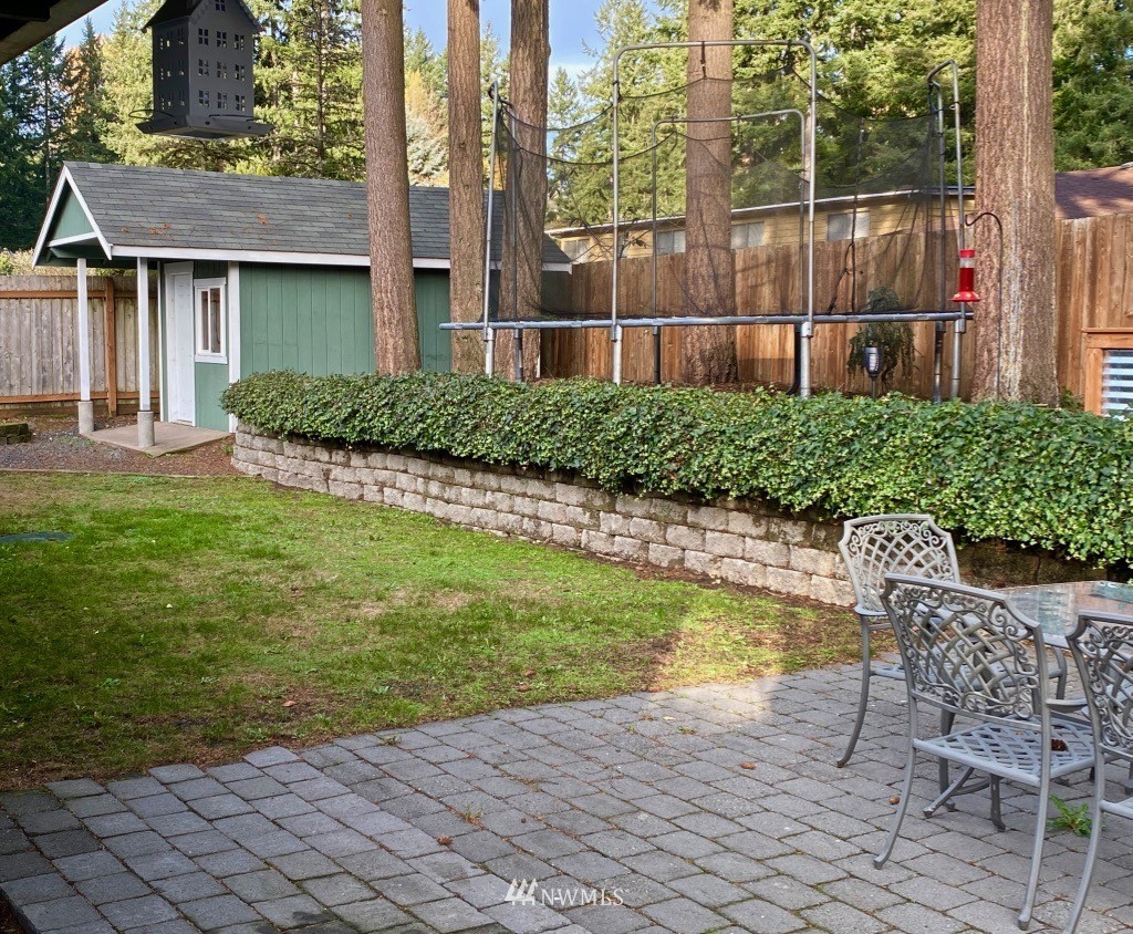 14530 166th Place Southeast Renton, WA 98059 - Photo 28 of 30 a view of a chair and table in backyard of the house